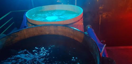 two large buckets of water sitting next to each other at Vila Alunis in Buşteni