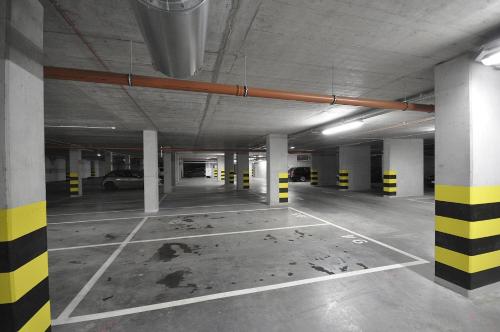 an empty parking lot in an empty parking garage at Schindler’s Factory Zabłocie Deluxe Apartments WAWELOFTS in Kraków
