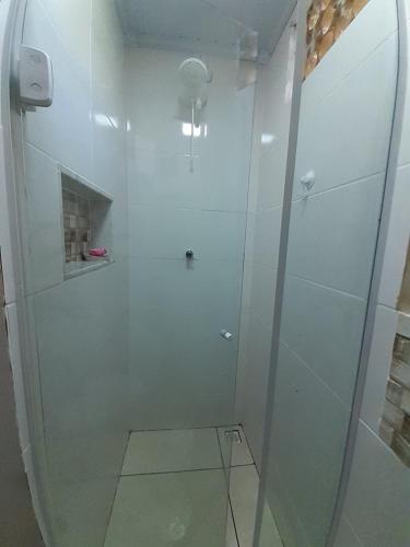 a shower with a glass door in a bathroom at Suíte da Vila - Beira Mar in Abraão
