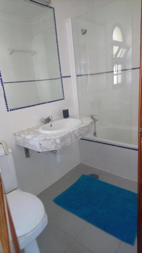 a bathroom with a sink and a toilet and a mirror at fuerte blue in Costa Calma