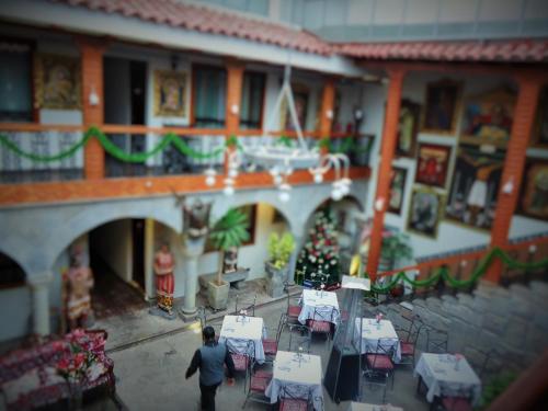 a model of a building with a christmas tree and tables at Hotel San Francisco Plaza in Cusco