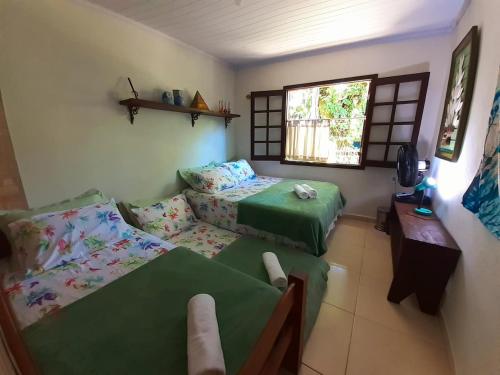 Ένα ή περισσότερα κρεβάτια σε δωμάτιο στο Casa inteira Ilha Grande