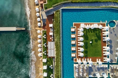 an aerial view of a resort with a pool and beach at Lesante Blu, a member of The Leading Hotels of the World - Adults Only in Tragaki