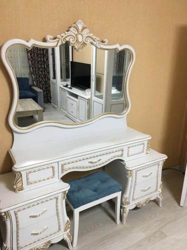a white dressing table with a mirror on it at Квартира в центре города in Tashkent