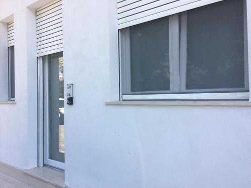 a close up of a window on a white building at Affittacamere LA PISANA in Porto SantʼElpidio