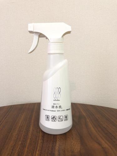 a white spray bottle sitting on a wooden table at Kansai Airport First Hotel in Izumi-Sano