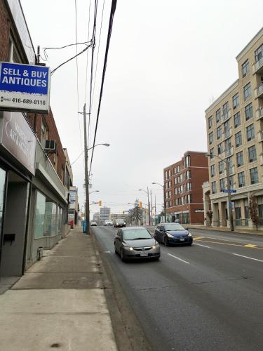 a street with cars parked on the side of the road at Cozy Private Rm Heart of North York Free Parking Full Kitchen Close to Downtown in Toronto