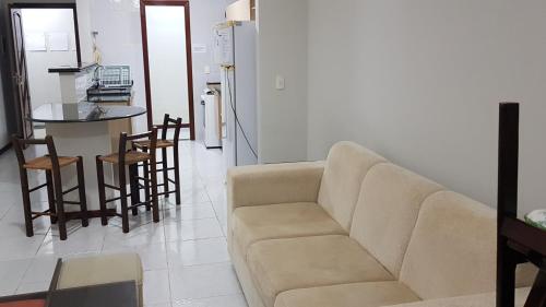 a living room with a couch and a kitchen at Ocean View Tabatinga Residence in Barra de Tabatinga