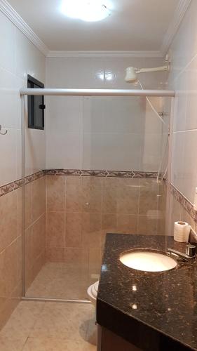 a bathroom with a shower with a sink and a toilet at Ocean View Tabatinga Residence in Barra de Tabatinga