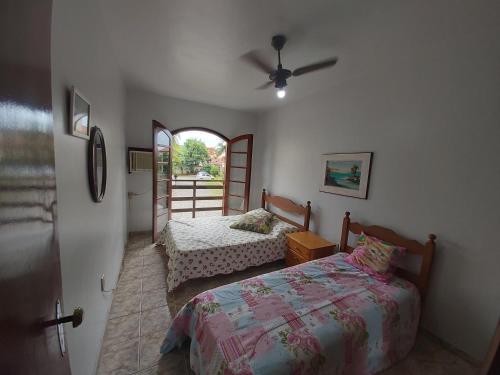 Ένα ή περισσότερα κρεβάτια σε δωμάτιο στο Vivendas de Iguaba