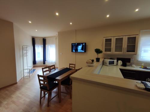 a kitchen and living room with a table and chairs at Budapest Airport , accommodation in Vecsés in Vecsés