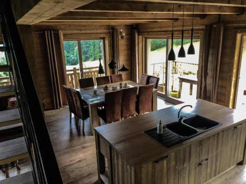 a kitchen and dining room with a table and chairs at Chata Čerenka in Bytca