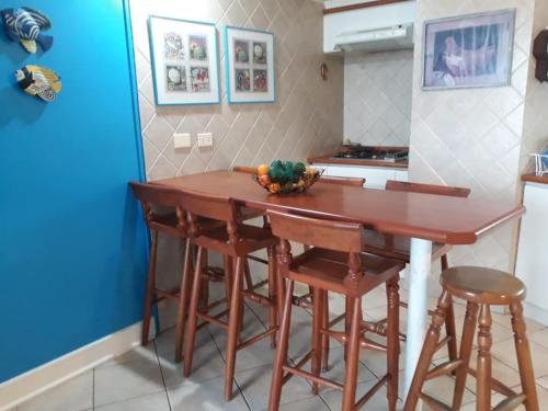 a kitchen with a wooden table and stools at Edificio Costa del Este - Resort in Concón