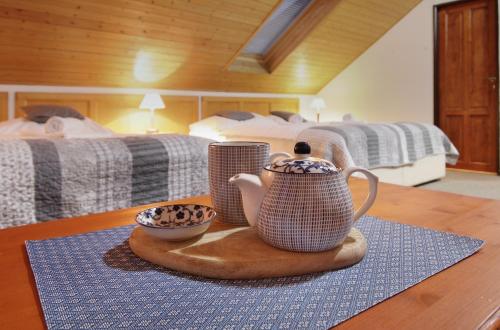 a room with two beds and two cups on a table at Hotel Hvezda in Pec pod Sněžkou