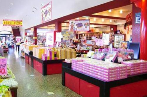 a store with pink and yellow items on display at 読谷村カービラハウス ow3 in Jima