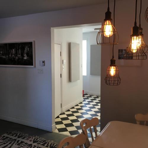 a dining room with a table and chairs and lights at L'Hotel Particulier Griffintown in Montréal