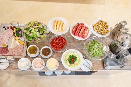 a table filled with different types of food in bowls at Manh Quan Luxury Hotel in Yen