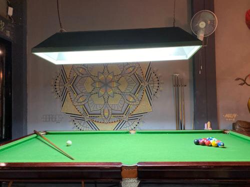a pool table with balls on it in a room at Monkey Toe Guesthouse in Chiang Mai