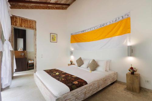 a bedroom with a bed with a flag on the wall at The Bejalin Eco Retreat in Plaga