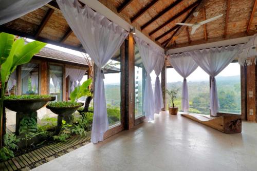 a room with windows and curtains in a building at The Bejalin Eco Retreat in Plaga