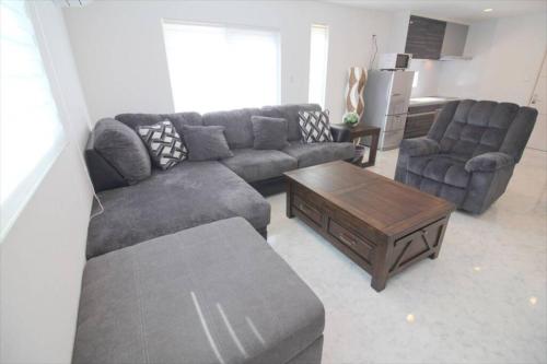 a living room with a couch and a coffee table at Casa de nicki 恩納村 in Onna