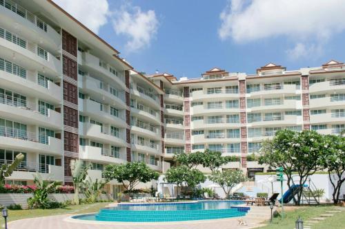 a large apartment building with a swimming pool at SeaRidge Hua Hin Resort & Poolvilla in Khao Tao