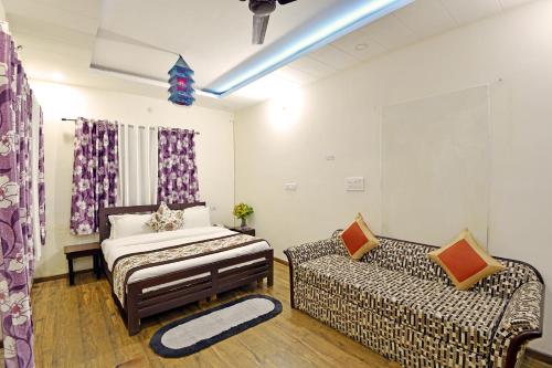 a living room with a bed and a couch at Green Roof Hotel in Nainital