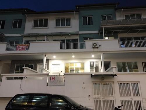 a car parked in front of a building at Island Hostel Bayan Lepas Airport in Bayan Lepas