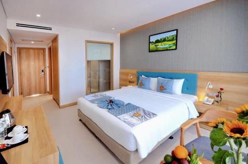a bedroom with a large bed in a room at Sun Kiss Hotel in Nha Trang