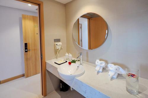 a bathroom with a sink and a mirror at Sun Kiss Hotel in Nha Trang