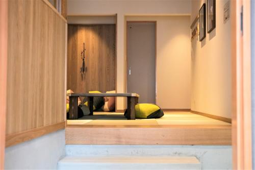 a room with a yellow pillow sitting on a shelf at MUSUBI HOTEL MACHIYA Naraya-machi 2 in Fukuoka