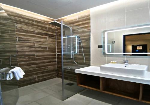 a bathroom with a sink and a mirror at Roxy Hotel Padungan in Kuching