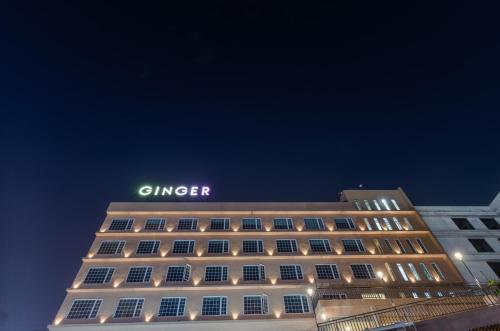 a building with a lit up sign on top of it at Ginger Surat City Centre in Surat