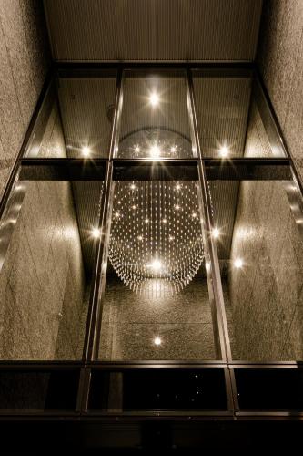 a glass ceiling with a chandelier in a room at Hotel Dans Le Coeur Osaka Umeda in Osaka