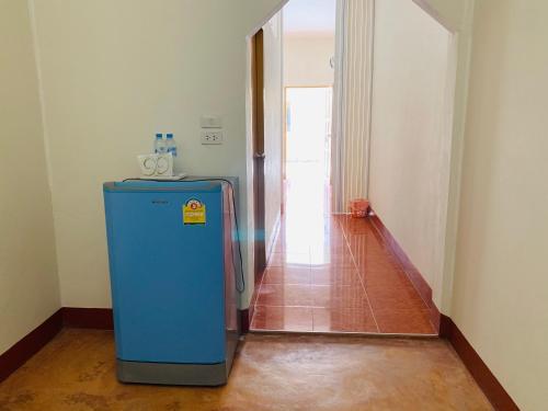 a blue refrigerator in a room with a hallway at ศรีสุภาวดีรีสอร์ท-Srisupawadee resort in Prachuap Khiri Khan