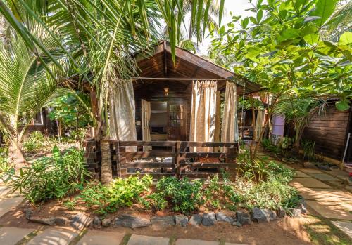 a small house in the middle of a forest at Simrose in Agonda