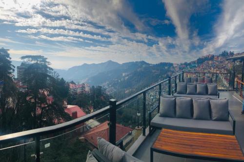a balcony with a view of the mountains at Hotel Willow Banks Shimla in Shimla