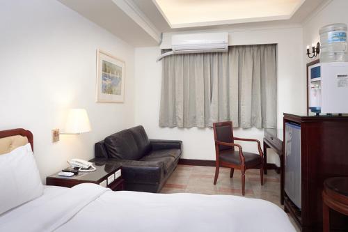 Postel nebo postele na pokoji v ubytování Peach Hotel