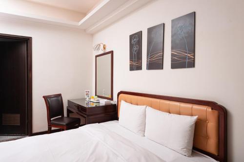 Postel nebo postele na pokoji v ubytování Peach Hotel