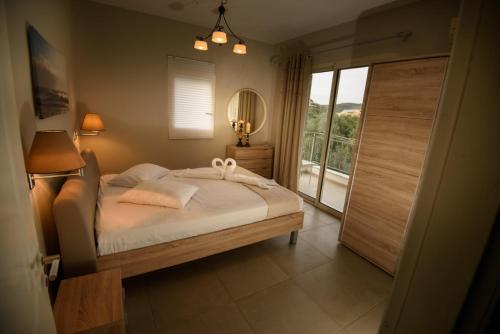 a bedroom with a bed and a large window at Sivotahomes-luxury in Syvota