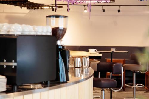 a restaurant with a bar with bar stools and a counter with a counter at Maverick Central Market in Budapest