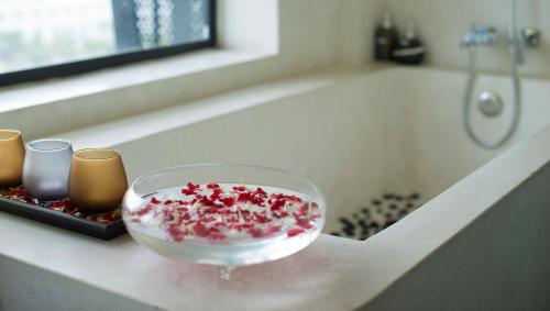 a bowl on a counter next to a bath tub at Almond Hotel Bassac River in Phnom Penh