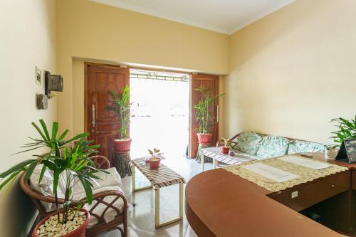 a living room with potted plants and a table at RedDoorz Syariah @ Sakinah Guesthouse in Sragen