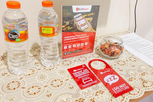 a table with two bottles of water and a box at RedDoorz Syariah @ Sakinah Guesthouse in Sragen