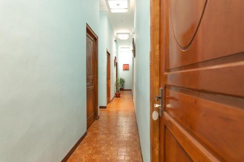 a hallway with a wooden door and a hallway with at RedDoorz Syariah @ Sakinah Guesthouse in Sragen