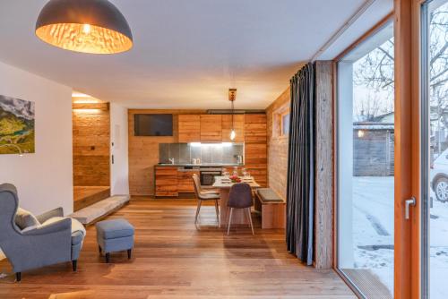 a kitchen and living room with a table and chairs at Biochalet-Ebenbauer in Schladming