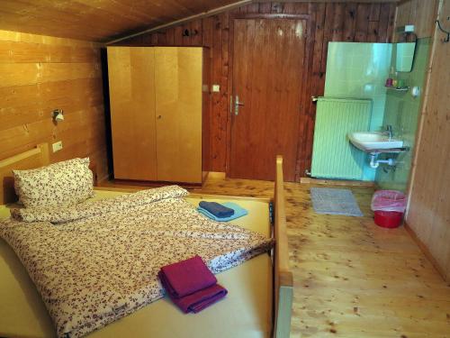 a bedroom with a bed and a sink in a room at Stampferhof in Matrei in Osttirol