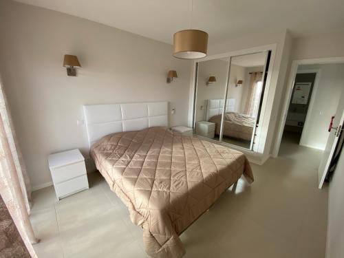 a bedroom with a bed and a large mirror at Albur Village B - Gerbera in Alvor
