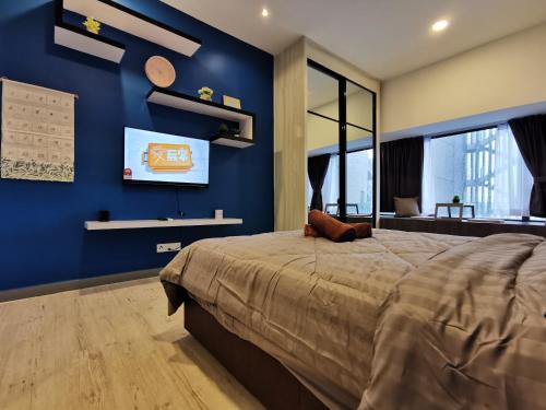 a bedroom with blue walls and a large bed at Thermospace Imperio A-17-19 Melaka City in Melaka