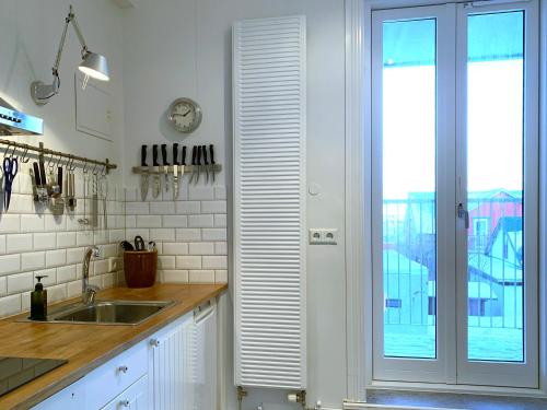 a kitchen with a sink and a sliding glass door at Nest Apartments in Reykjavík